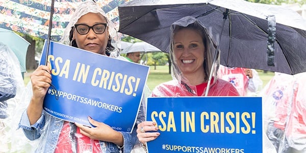 AFGE activist with rally signs