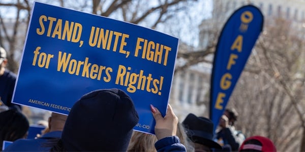 AFGE rally sign that reads Stand, Unite, Fight for Workers' Rights