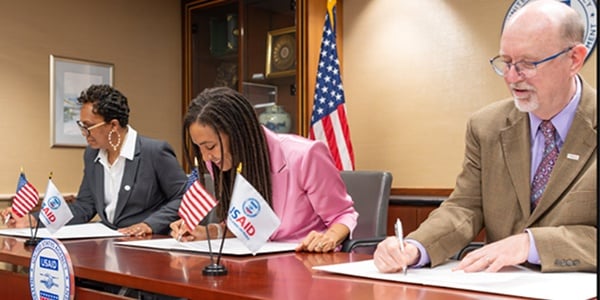 Workers signing a document