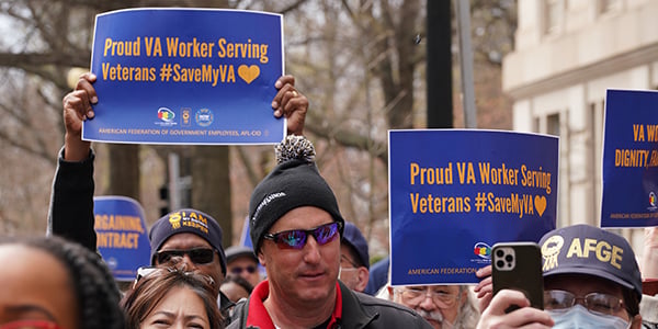 AFGE activists at rally holding signs