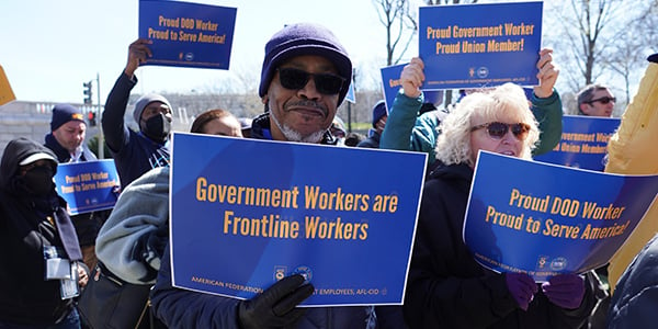 AFGE activist holding rally sign. 